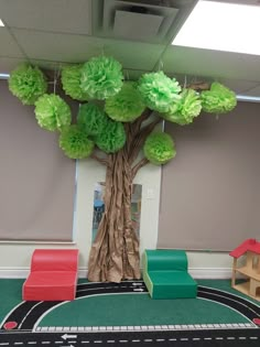 a tree with green tissue paper flowers on it