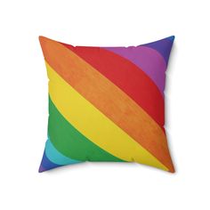 a rainbow colored pillow on a white background