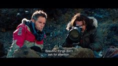 two people sitting on rocks with a camera in front of them and the words beautiful things don't ask for attention