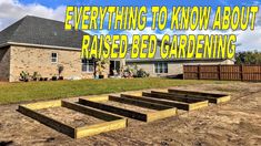 a yard with some wooden steps in the dirt and a house behind it that says everything you need to know about raised bed gardening