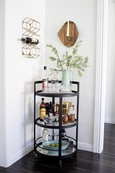 a black bar cart with drinks on it