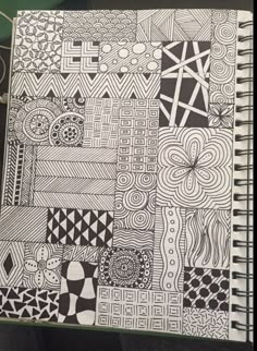 a notebook with black and white designs on it