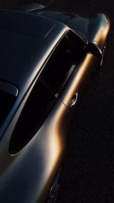 an overhead view of a car parked in a parking lot with the sun shining on it