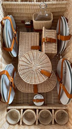 a wicker basket filled with plates and bowls