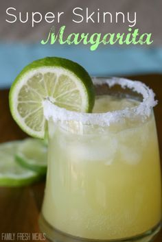 a close up of a margarita drink with limes