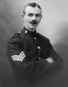 an old black and white photo of a man in uniform with a moustache on his face