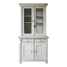 an old white china cabinet with glass doors and drawers on the bottom, against a white background