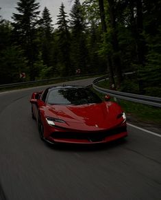 a red sports car driving down the road