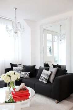 a living room filled with furniture and a large mirror