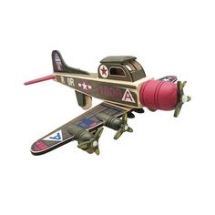 a toy airplane flying through the air with a red ball on it's nose