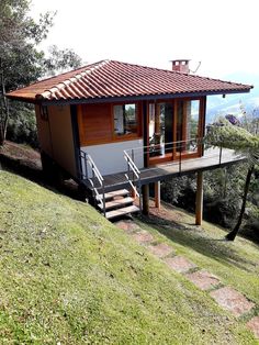 a small house with stairs leading up to it