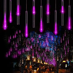 purple lights are hanging from the ceiling in front of a building