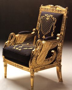 an ornately decorated gold and black chair