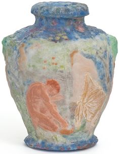 a vase with an image of two people sitting on the ground next to each other