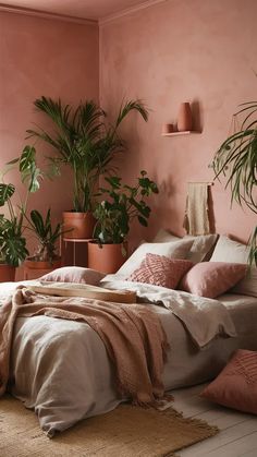 a bedroom with pink walls and lots of plants