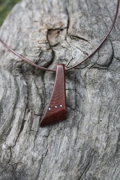 "Adorned with 3 Sterling silver dots, this outstanding and unique hand-carved 6000 year old Irish Bog yew pendant has been made for you, or a loved one, in my studio on the West of Ireland. Bog Yew comes from ancient forests that once covered Ireland. Huge Yew trees have been buried in peat bogs and preserved from decay by the acidic and anaerobic bog conditions, sometimes for hundreds or even thousands of years. The wood is usually stained brown by tannin dissolved in the acidic water. Bog-wood Wooden Pendant Necklace Handmade, Handmade Artisan Wood Necklaces, Wood Jewerly, Artisan Natural Wood Necklaces, Handmade Wooden Spiritual Necklaces, Artisan Natural Wood Pendant Necklace, Wood Jewelry Diy, Wood Jewelery, Old Irish