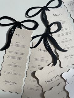 two black and white menus tied with ribbon