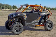 the polaris rzr xp4 is parked on dirt