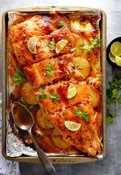 a pan filled with chicken, potatoes and lemons