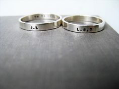 Celebrate your love, friendship, family connections with this matching set of solid sterling* personalized couple rings!  Perfect as simple, elegant, wedding rings, promise rings or anniversary rings or just because.   These minimalist rings will stack well with the other rings you wear.  Details... This set of matching, solid sterling silver couple rings includes two 3mm wide bands. The outsides of the rings can be shiny, satin or wood textured.  (You can choose the texture from the drop down menu). Ordering and customizing... When you order you can put the details for your set of couple rings in the personalization box.  The letters/numbers/symbols are individually stamped by hand (not engraved).  Please specify your size and word/date details.  For example: ring 1 - size 6 (inside) I LO Simple Elegant Wedding Rings, Wedding Ring Simple, Silver Couple Rings, Rings For Wedding, Elegant Wedding Rings, Rings Promise, Personalized Ring, Personalized Couple, Tiny Heart