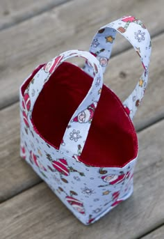 a small white bag sitting on top of a wooden table