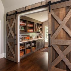 an open barn door leading into a kitchen