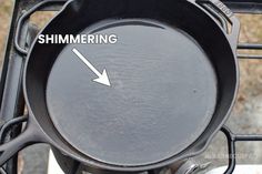 an empty frying pan sitting on top of a stove with the words shimering above it