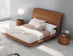 a modern bedroom with white carpet and wooden furniture