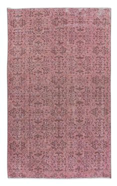 a pink rug with an intricate design on the top and bottom, it is made out of