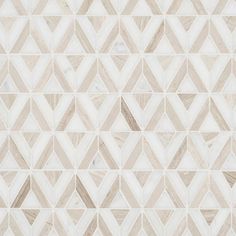 a white and beige tile wall with geometric shapes