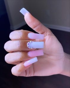 a person with pink and white nail polish holding up their finger to show off the manies