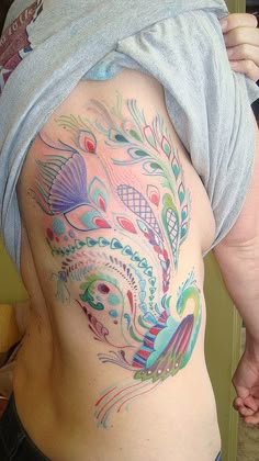 a man with a colorful tattoo on his back