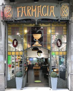 the entrance to farmaca is decorated with glass windows and metal trimmings