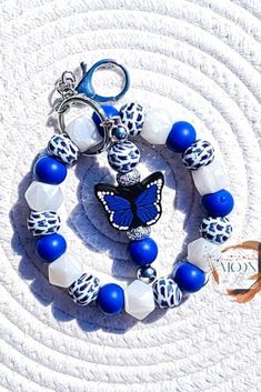 a blue and white bracelet with a butterfly charm