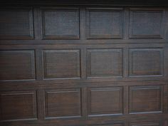 a brown garage door with the top panel missing