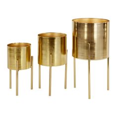 three brass planters and two metal candlesticks