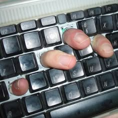 two fingers that are on top of a keyboard