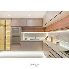 a modern kitchen with marble counter tops and stainless steel appliances