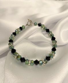 Classic Green Black Dainty beaded bracelet with toggle clasp Perfect gift for your mom, daughter, girlfriend, wife, best friend, for any occasion, Birthday, Wedding, Christmas, New Year, Valentine's Day, Anniversary, Friendship, Holiday, Graduation Gift. This beautiful handmade piece is ready to ship.  Materials Used: Wire, Toggle Clasp, crimp beads, bottle green beads, black beads, silver toggle How to Measure your size:  1. Wrap a measuring tape around your wrist. 2. Add 1/2 inch to 1 inch. For example, if your wrist size is 7 inches, add one inch, so 8 inches bracelet length will fit you well. A similar design can be custom made to your preference. Please feel free to send me a message and we can work on creating a beautiful bracelet for you or your loved ones.  Thank you for visiting m Green And Black Jewelry, Affordable Handmade Green Friendship Bracelets, Wrap Beaded Bracelet, Cheap Green Beaded Bracelets For Birthday, Green And Black Bracelet, Green Bead Bracelet Ideas, Friendship Bracelets Green, Green Bracelet Beads, Green Bracelet Ideas