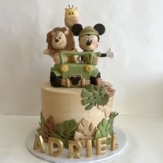 a birthday cake with mickey mouse and friends on top