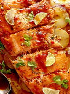 a close up of food on a plate with lemons and garnishes