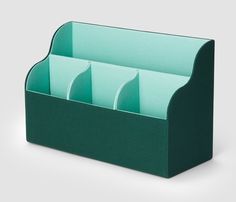 a green desk organizer with four compartments on the front and one section open to show files