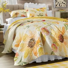 a bed covered in yellow and orange flowers