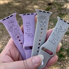 a person holding four different colored watch bands in their hand with the words peace written on them