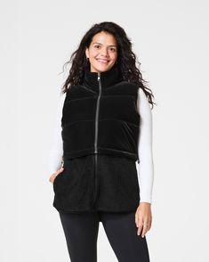 This two-in-one vest helps you brave the chill in style and comfort. On colder days where you need extra warmth and coverage all around, the zip-up long vest option will be your go-to layer. On slightly warmer days, simply remove the bottom fleece portion to reveal a perfectly cropped velour vest that flatters any high-waisted look. With convenient, fleece-lined hand pockets and a shock cord at the hem to define your waist, this fully-lined layer is every bit as flattering as it is versatile. | Spanx Women's Two-In-One Velour Fleece Vest Top Long Vest, Long Vests, Fleece Vest, Vest Top, Cold Day, Zip Up, Outerwear Jackets, In Style, Brave