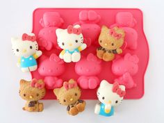 hello kitty cookies are arranged on a pink tray