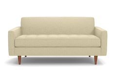 a beige couch sitting on top of a white floor