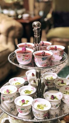 there are many cups and saucers on the trays that have flowers on them