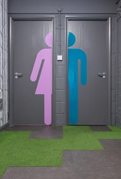 two restroom doors with different colored signs on them