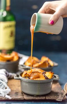 a person pouring caramel sauce on some food